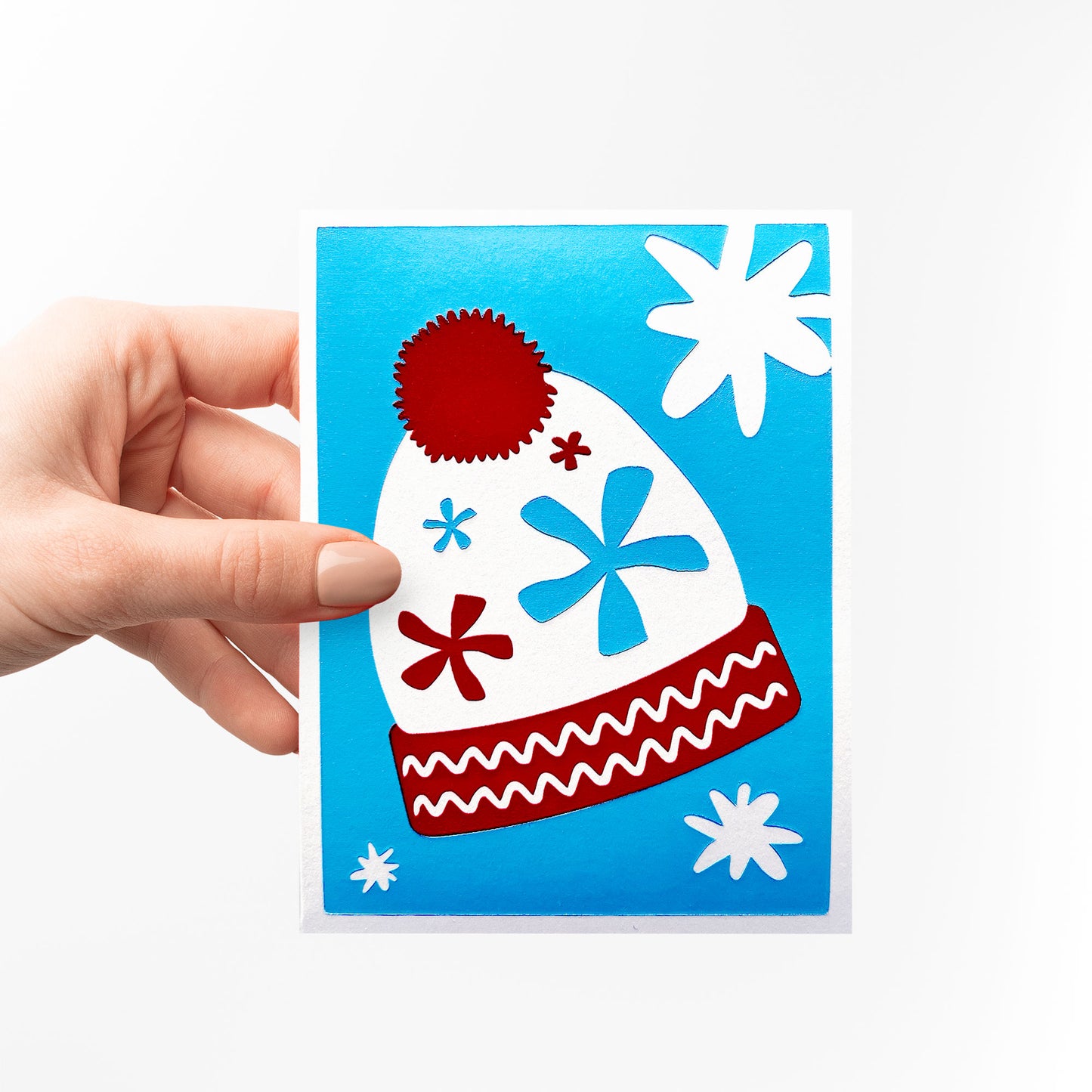 A hand holding the Twinkling Beanie Card, emphasizing its size and vibrant colors.