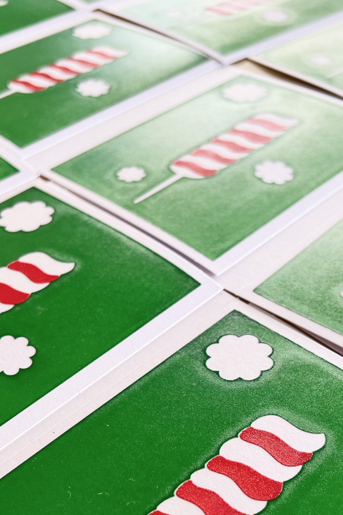 McWu screen-printed goods flat lay — greeting cards, pocket notebooks, and dishcloths made in Los Angeles